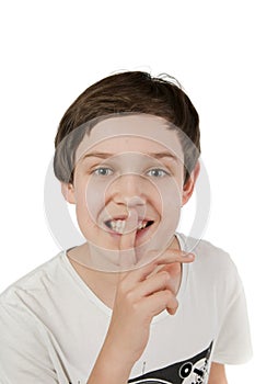 Boy finger on mouth and smiling photo